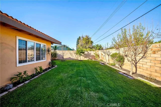 a view of an house with backyard space and garden