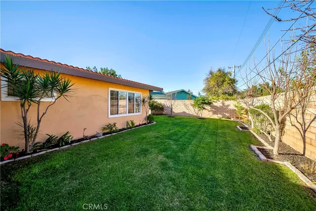 a backyard of a house with lots of green space and plants