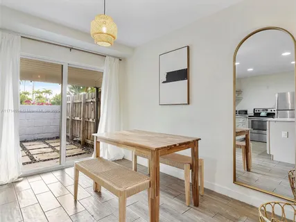 a view of a dining room with furniture and a chandelier