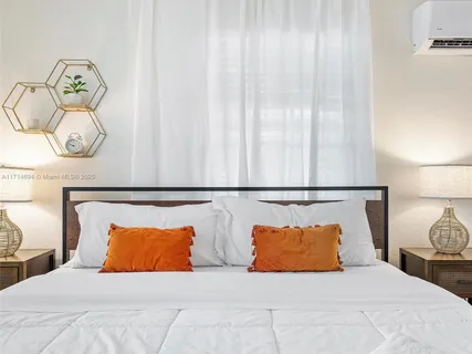 a bedroom with a bed and ceiling fan