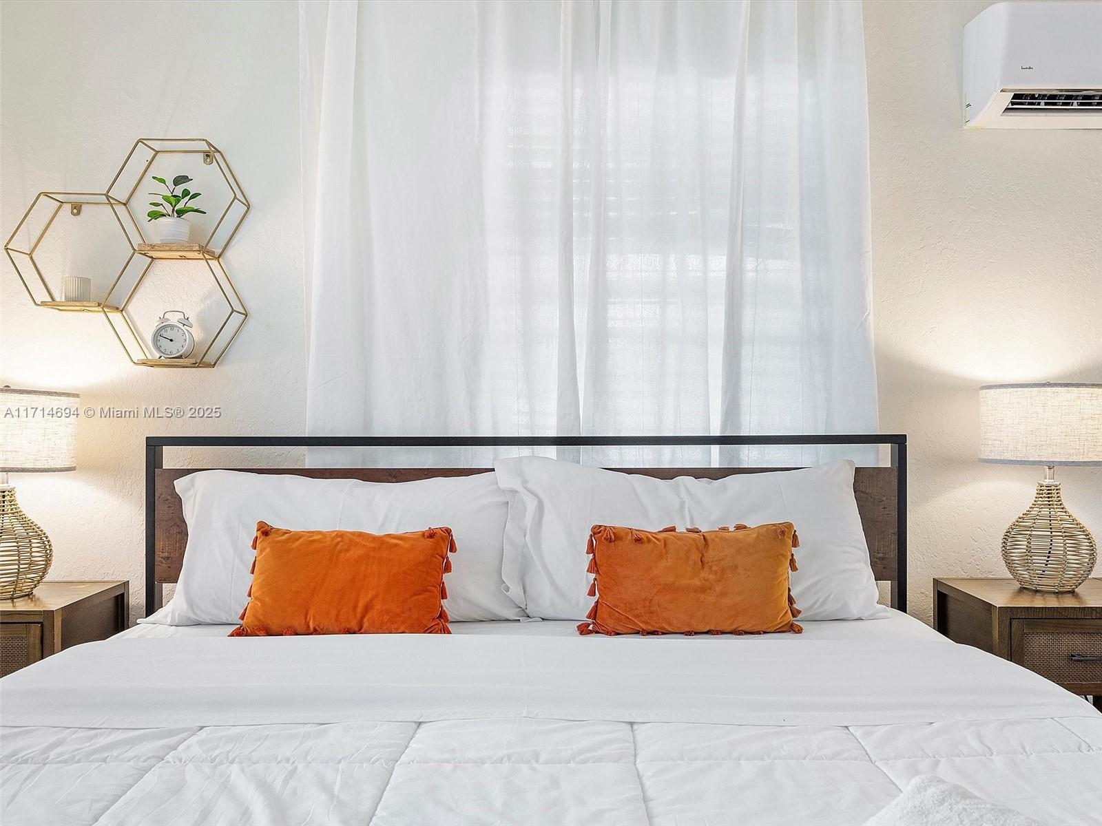 300 Southwest 23rd Street Fort Lauderdale, FL 33315 - Photo 27 of 43 a bedroom with a large bed and a potted plant