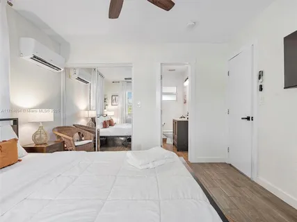 a bedroom with a large bed and a chandelier