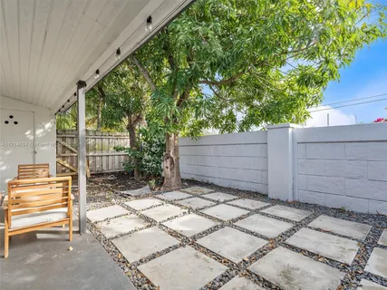 a view of a patio with a table and chairs and couches in a patio