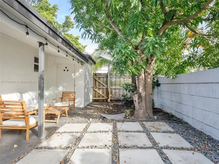 a backyard of a house with table and chairs