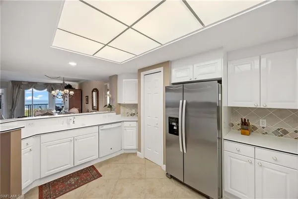 a kitchen with stainless steel appliances a refrigerator sink and cabinets
