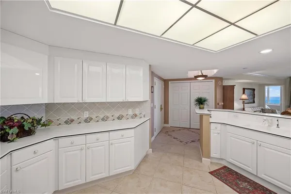 a kitchen with cabinets and window