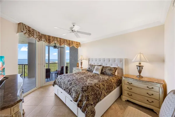 a spacious bedroom with a bed and wooden floor