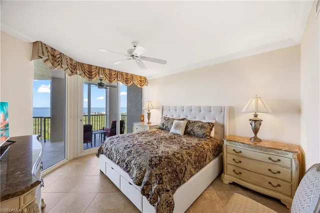 a spacious bedroom with a bed and wooden floor