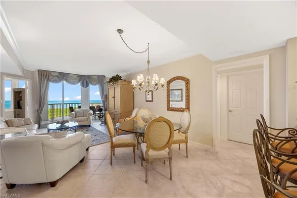 a living room with furniture chandelier and a chandelier
