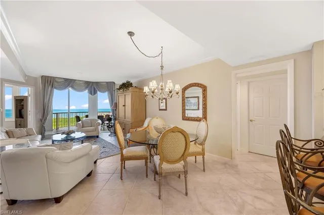 a living room with furniture chandelier and a chandelier
