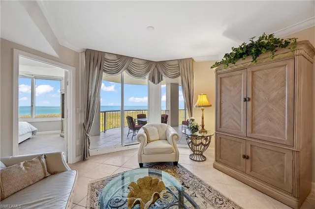 a spacious bedroom with a balcony a bed and a couch