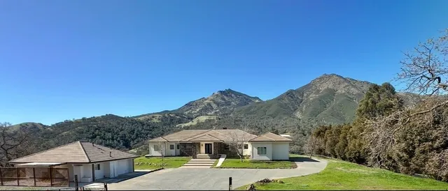 a view of a house with a yard and sitting area