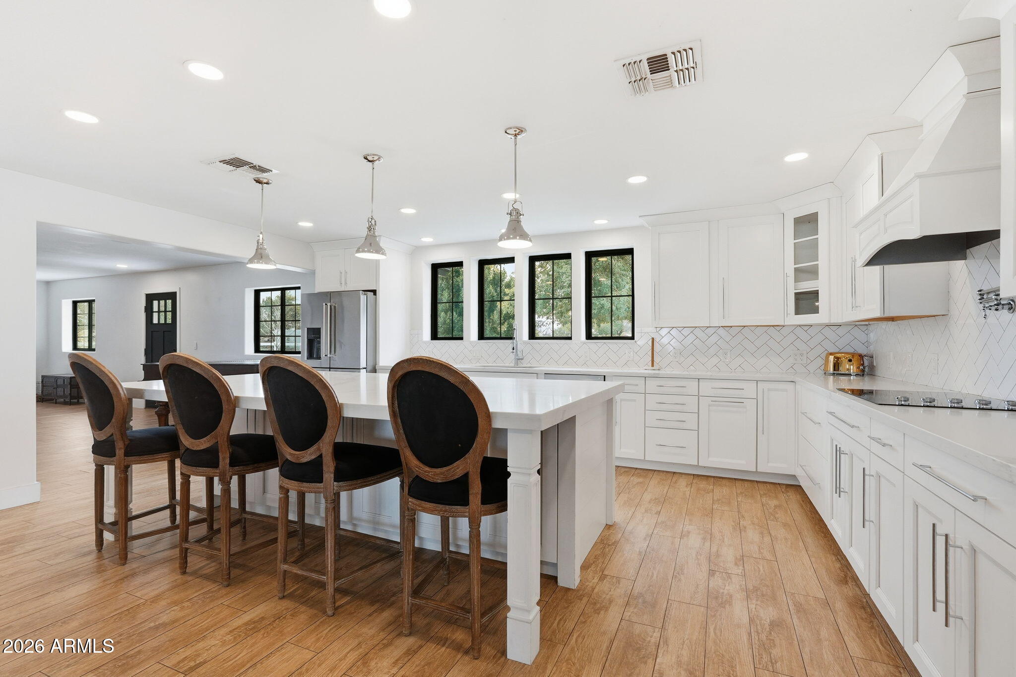 2858 East Redfield Road Gilbert, AZ 85234 - Photo 27 of 60 a kitchen with stove a sink a dining table and chairs