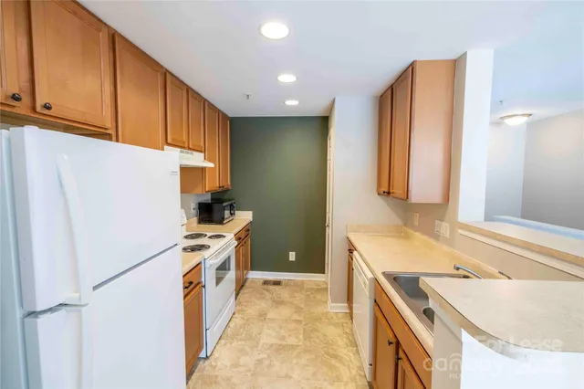 a kitchen with a sink stove and refrigerator
