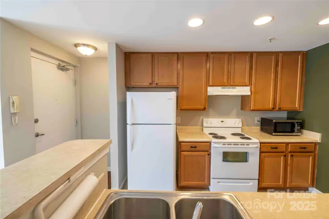 a kitchen with a stove and a refrigerator