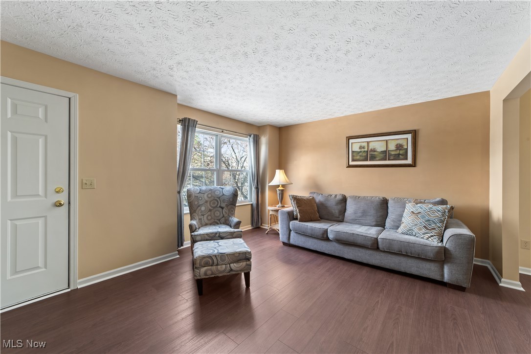 4364 Sexton Road Cleveland, OH 44105 - Photo 13 of 50 Living room featuring wood-style floors and a textured ceiling