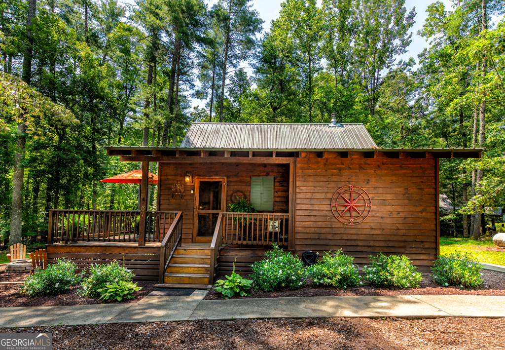 67 Big Tree Road Suches, GA 30572 - Photo 1 of 27 a front view of a house with garden
