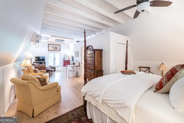 a spacious bedroom with a bed a couch and a walk in closet