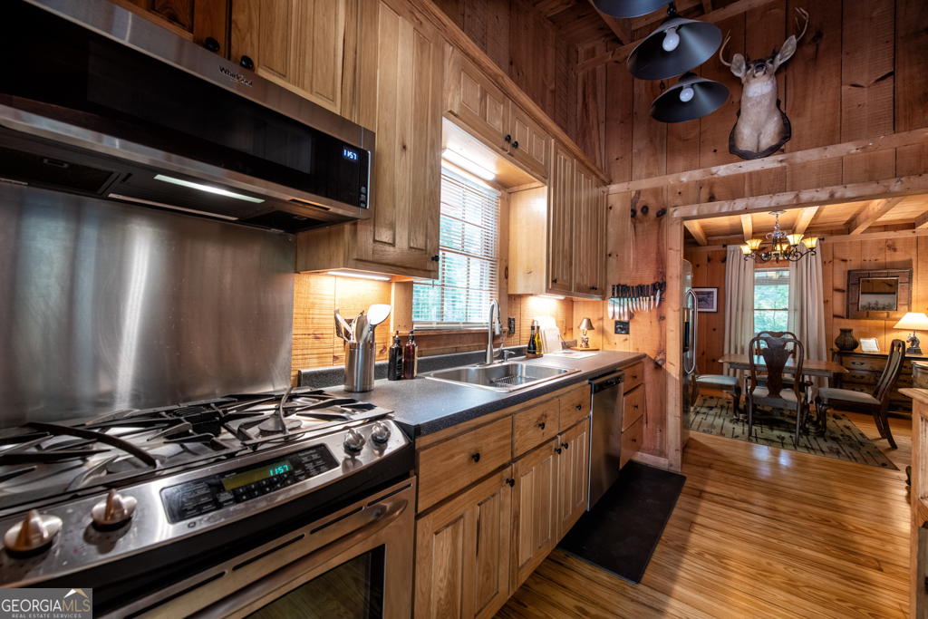 67 Big Tree Road Suches, GA 30572 - Photo 5 of 27 a kitchen with stainless steel appliances a stove a sink dishwasher and cabinets with wooden floor