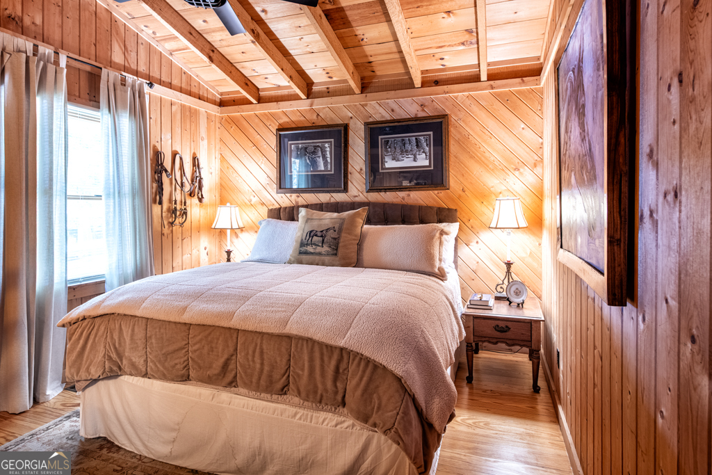 67 Big Tree Road Suches, GA 30572 - Photo 10 of 27 a bedroom with a bed and wooden floor