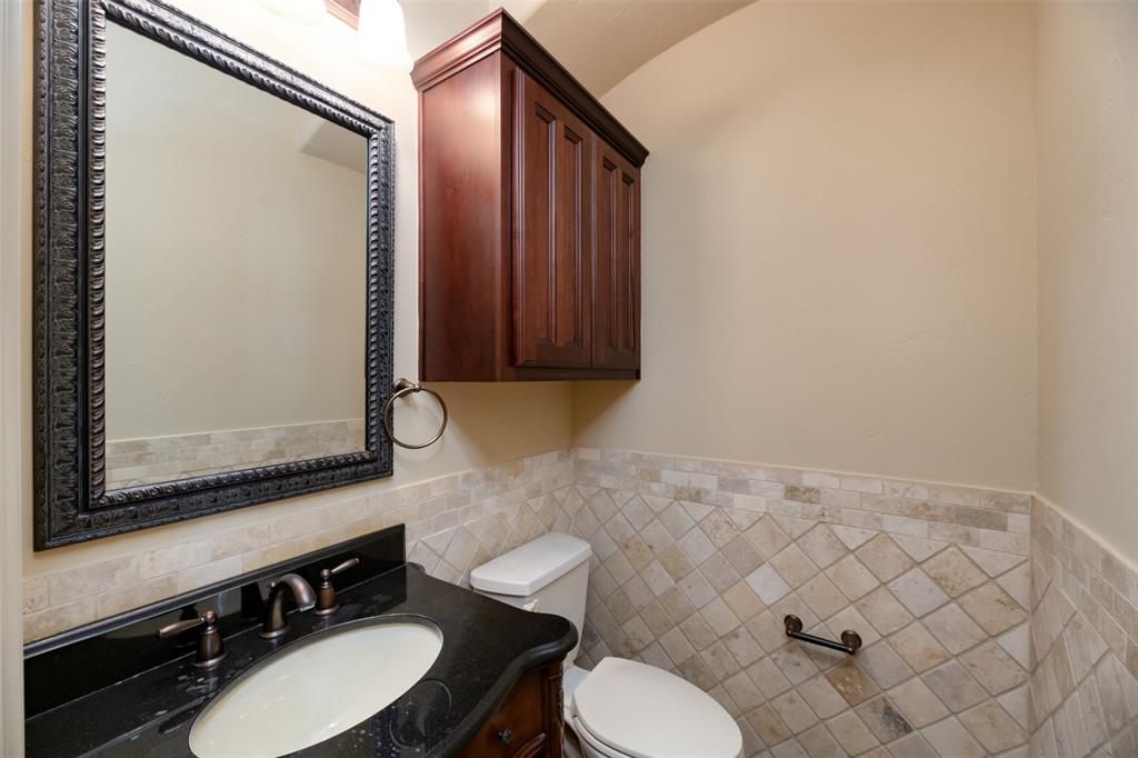 7914 Bishop Road Plano, TX 75024 - Photo 14 of 33 a bathroom with a sink mirror and toilet