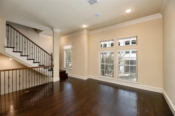 an empty room with closet and a ceiling fan