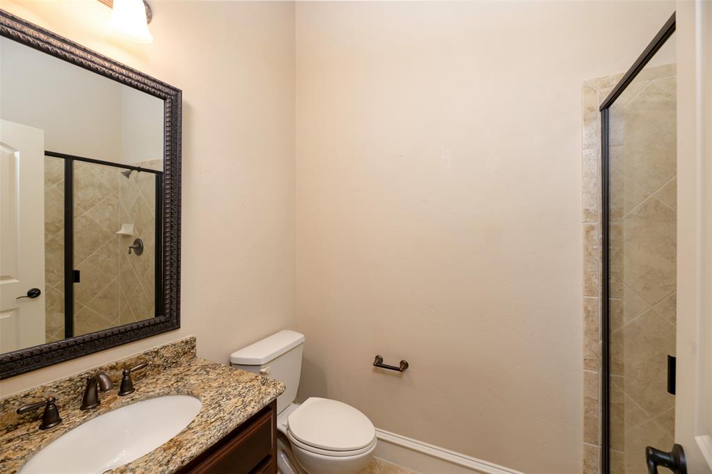 7914 Bishop Road Plano, TX 75024 - Photo 6 of 33 a bathroom with a granite countertop sink toilet and shower