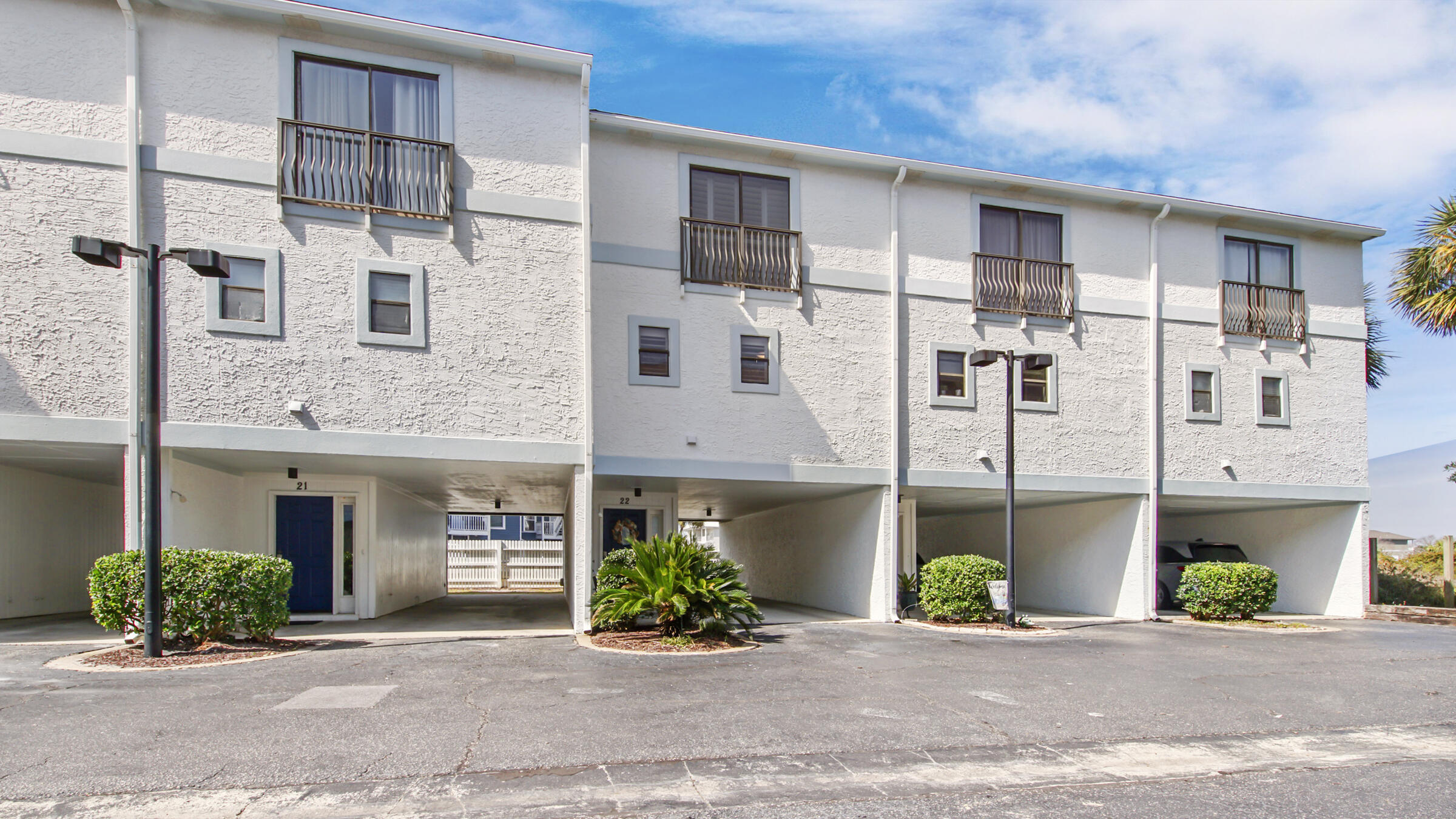 11 Driftwood Road, Unit 22 Miramar Beach, FL 32550 - Photo 2 of 29 a front view of a building with a garden and plants