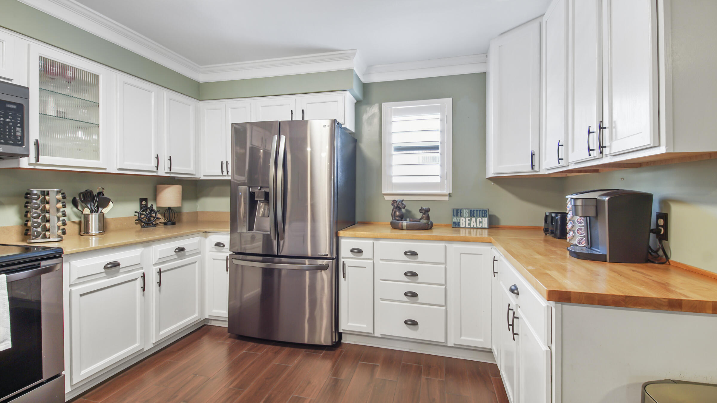 11 Driftwood Road, Unit 22 Miramar Beach, FL 32550 - Photo 3 of 29 a kitchen with granite countertop a refrigerator sink and cabinets