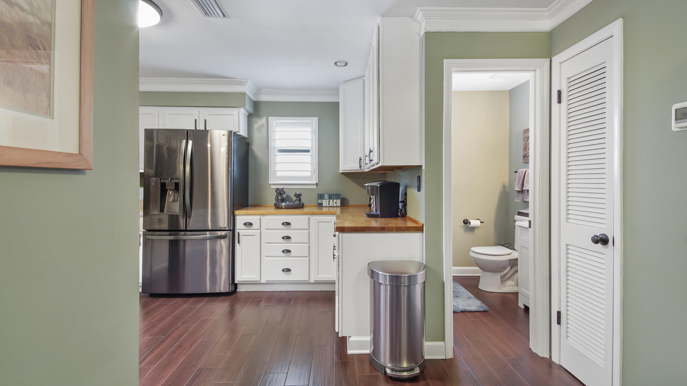 11 Driftwood Road, Unit 22 Miramar Beach, FL 32550 - Photo 4 of 29 a kitchen with a refrigerator and a wooden floor