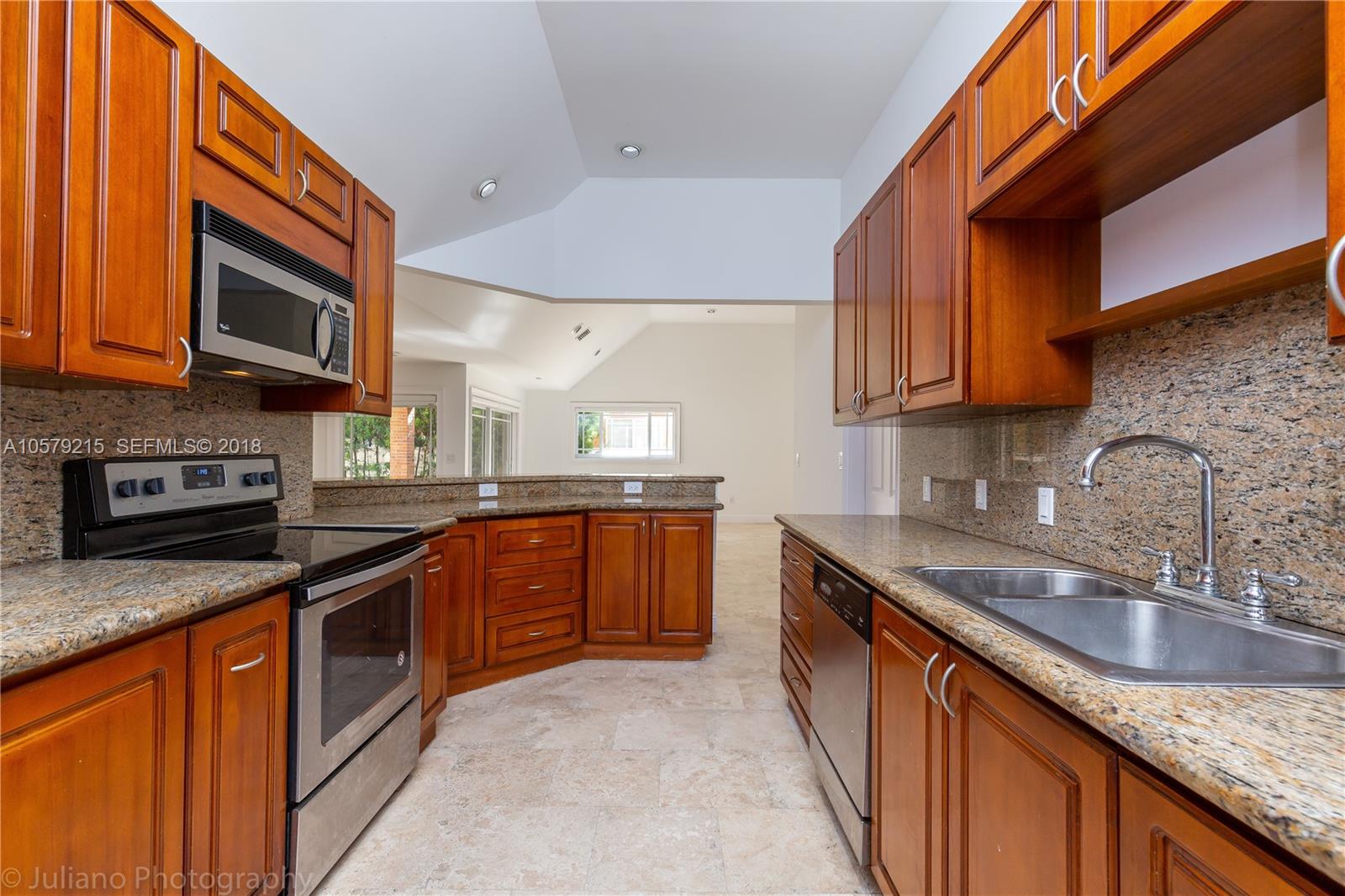 211 Southwest 29th Road Miami, FL 33129 - Photo 29 of 33 a kitchen with stainless steel appliances granite countertop a sink stove and microwave