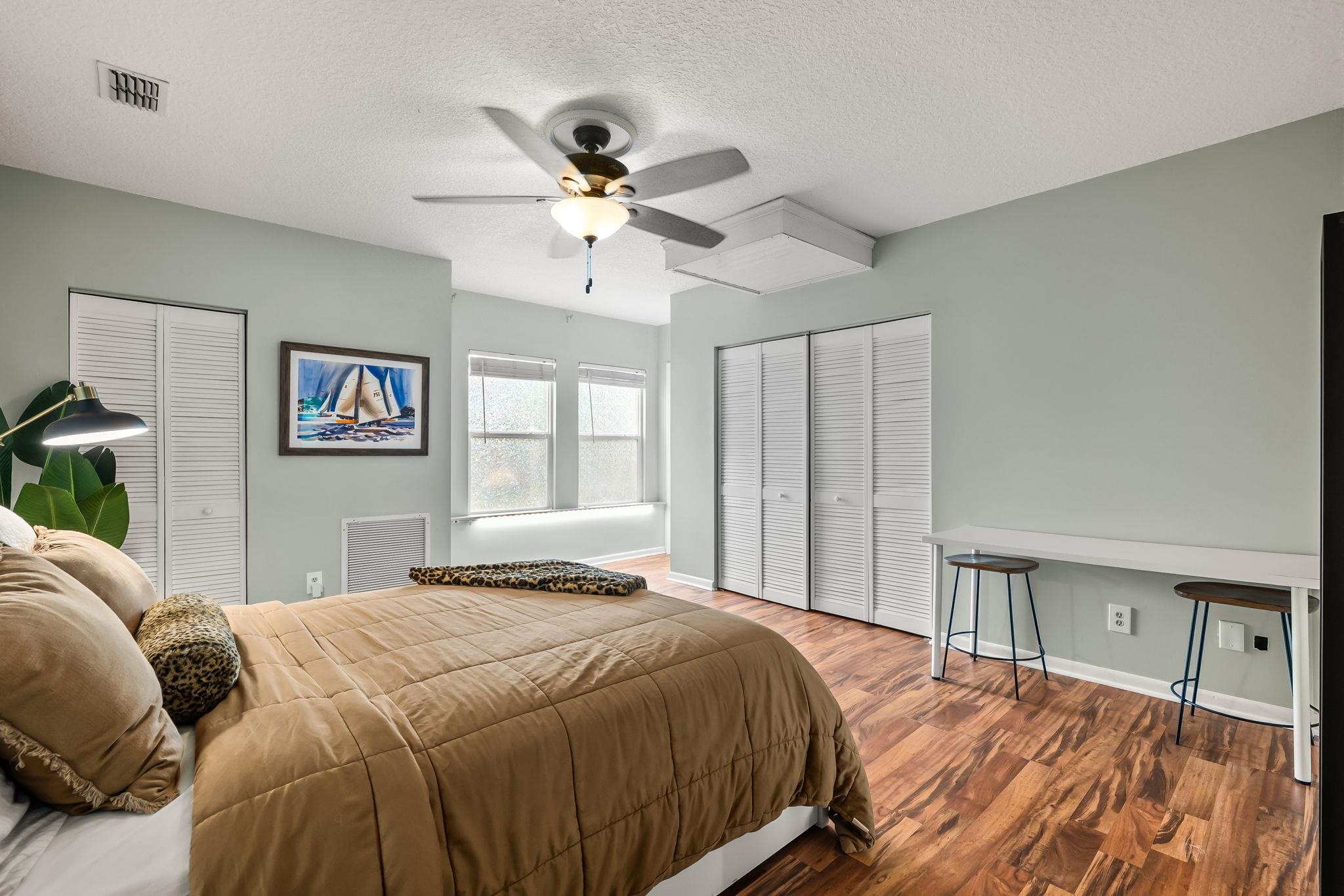 129 Pelican Road St. Augustine, FL 32086 - Photo 13 of 35 a bedroom with a large bed and a chandelier