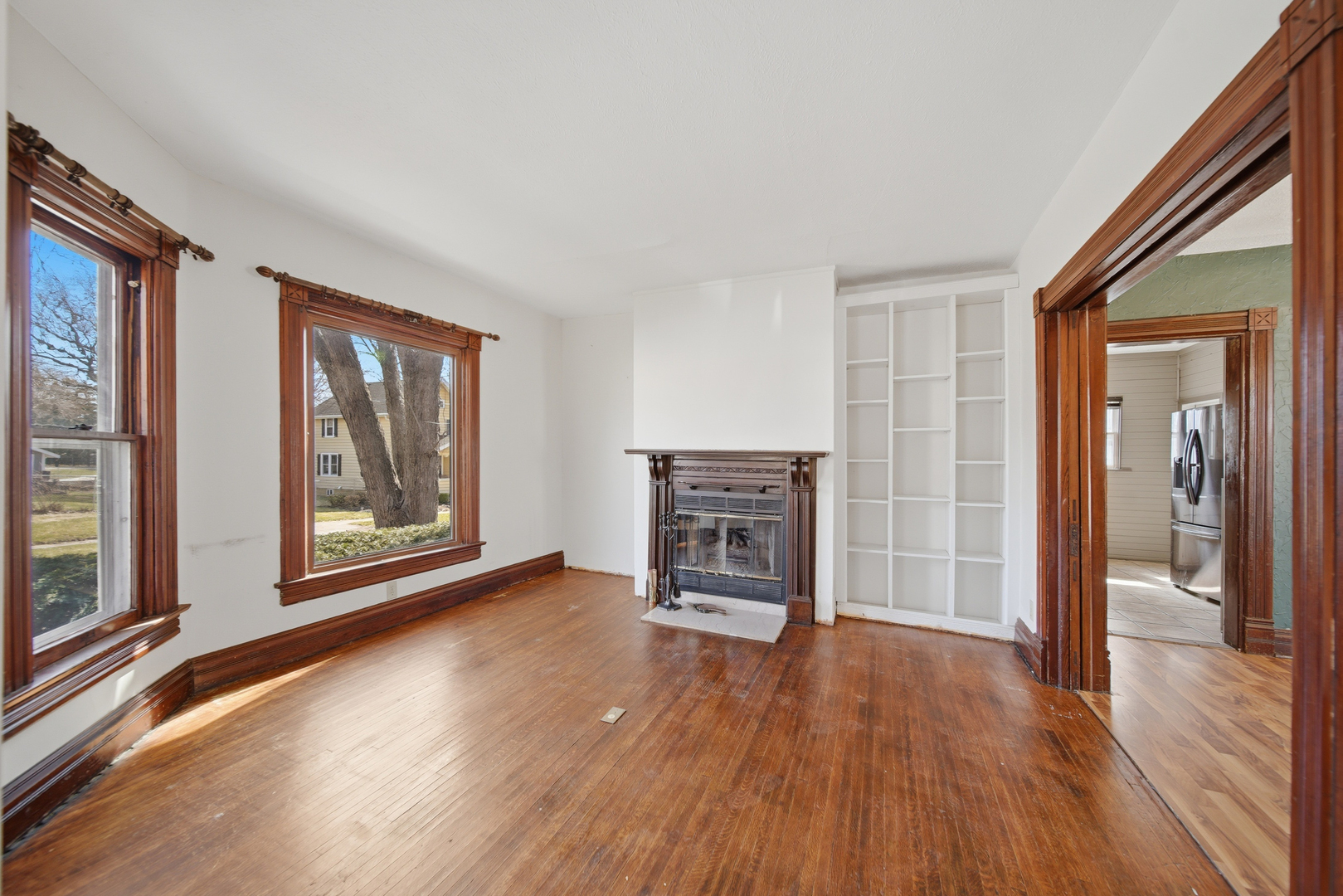 304 West Chamberlin Street Dixon, IL 61021 - Photo 12 of 28 a view of empty room with wooden floor and fireplace