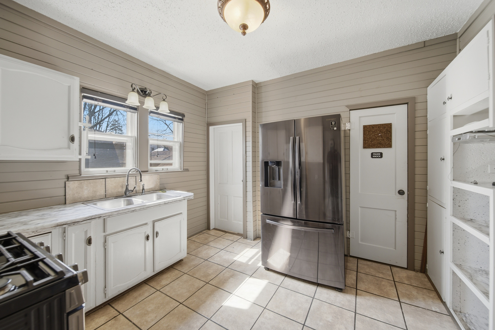 304 West Chamberlin Street Dixon, IL 61021 - Photo 17 of 28 a kitchen with a refrigerator a sink and cabinets