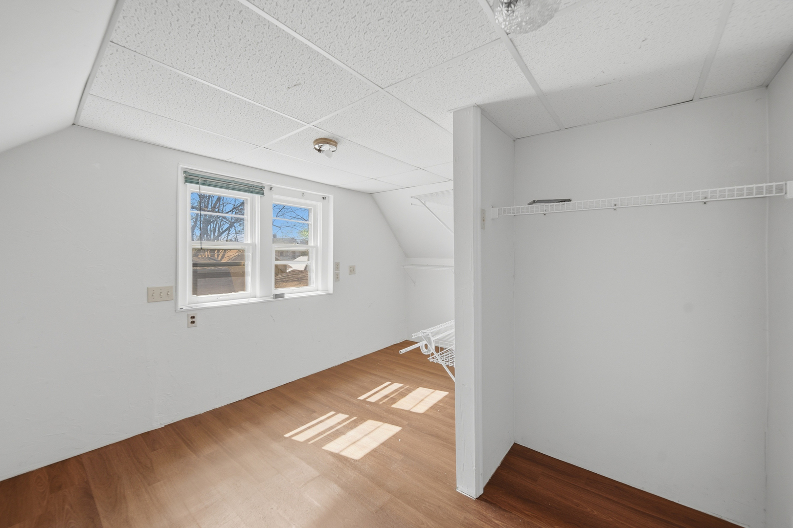 304 West Chamberlin Street Dixon, IL 61021 - Photo 23 of 28 a view of an empty room with wooden floor and a window