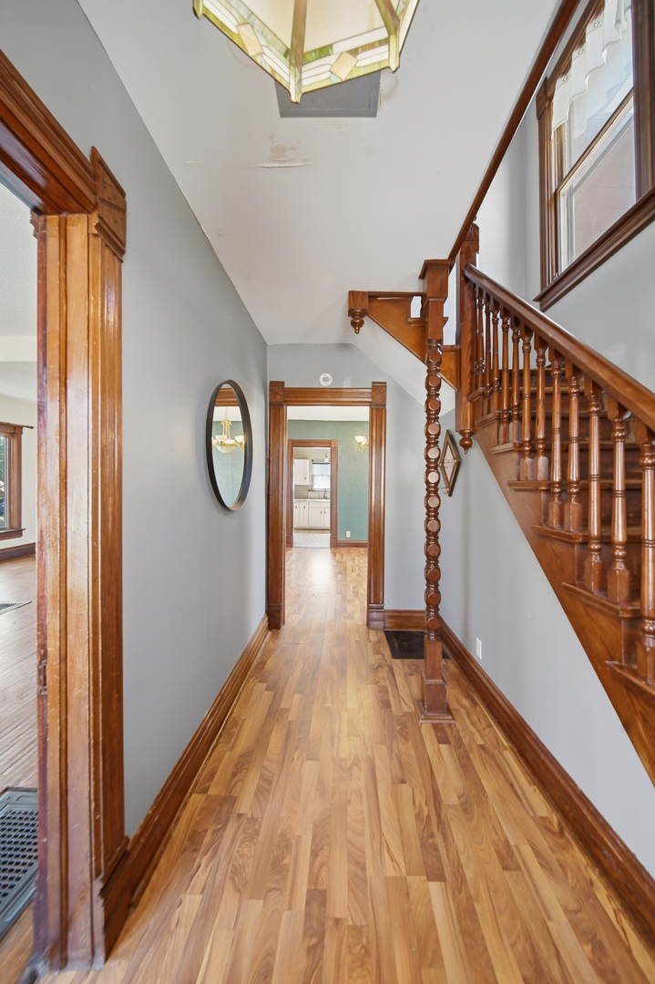304 West Chamberlin Street Dixon, IL 61021 - Photo 8 of 28 a view of a hallway with wooden floor and front door