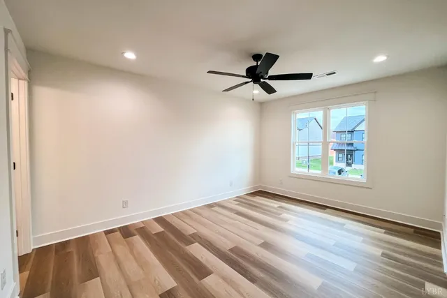 a view of a room with wooden floor and windows