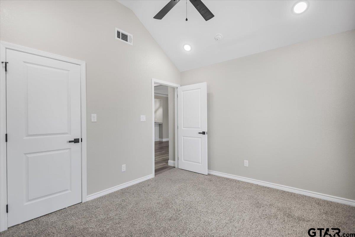 1607 North Ross Avenue Tyler, TX 75702 - Photo 15 of 39 an empty room with closet and a chandelier fan