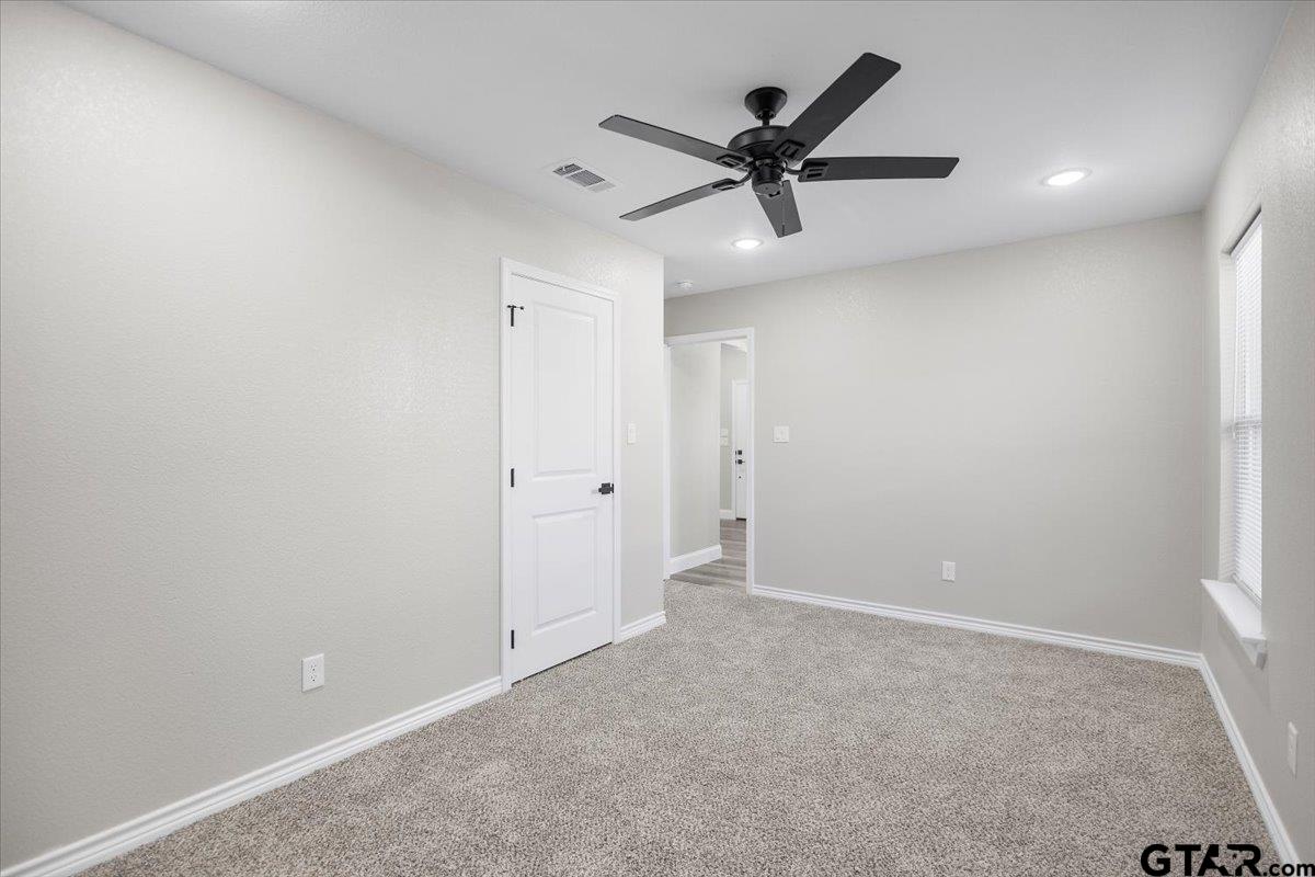 1607 North Ross Avenue Tyler, TX 75702 - Photo 19 of 39 a view of a big room with wooden floor and windows in a room