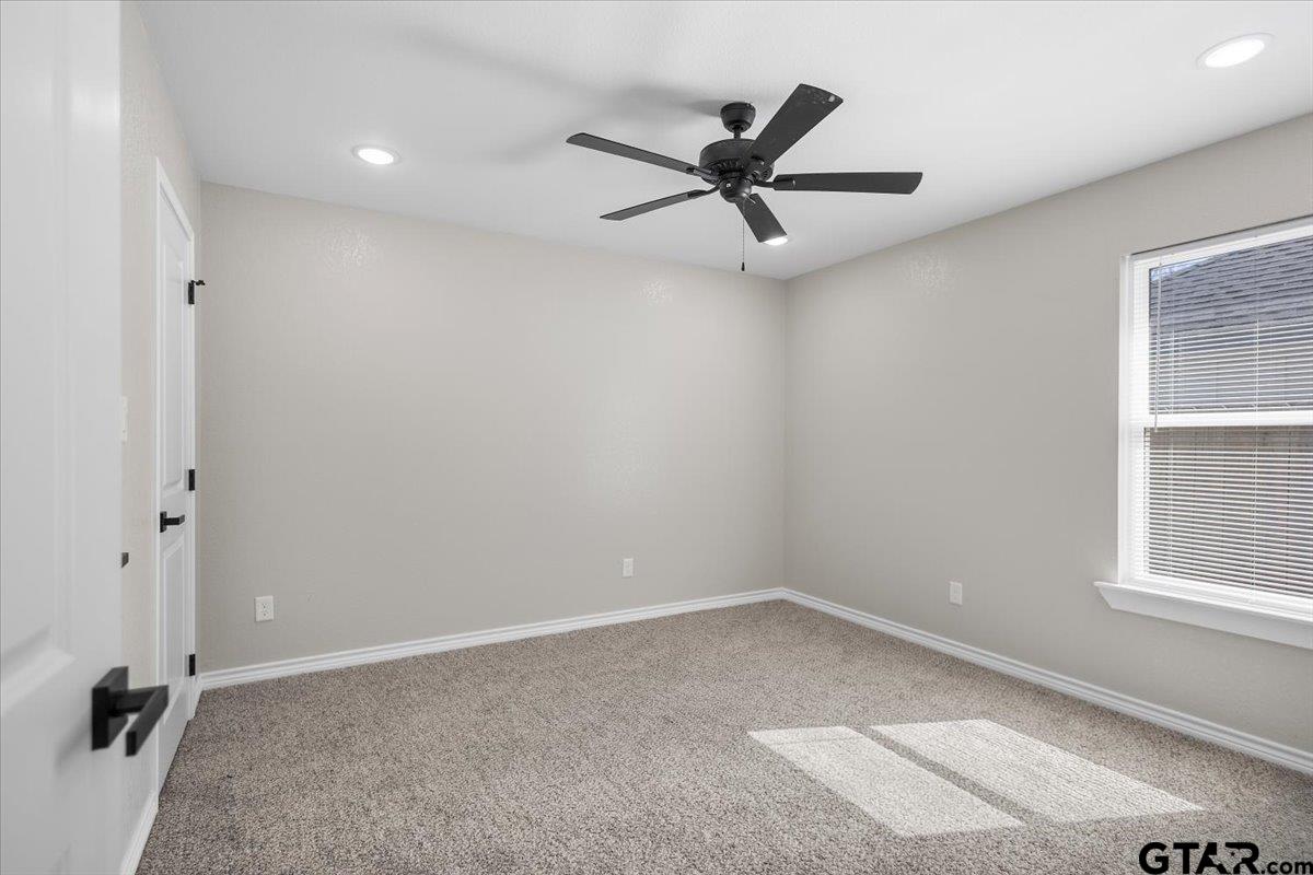 1607 North Ross Avenue Tyler, TX 75702 - Photo 25 of 39 an empty room with a window and a fan