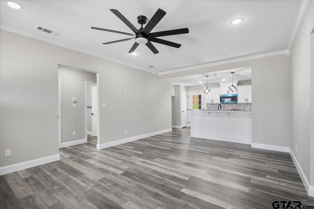 1607 North Ross Avenue Tyler, TX 75702 - Photo 5 of 39 a view of a kitchen with a dishwasher and wooden floor