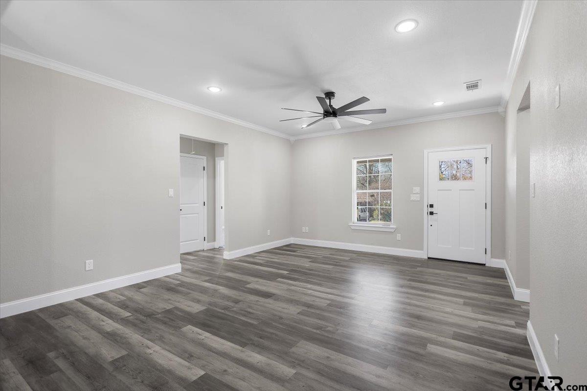 1607 North Ross Avenue Tyler, TX 75702 - Photo 7 of 39 a view of an empty room with window and wooden floor