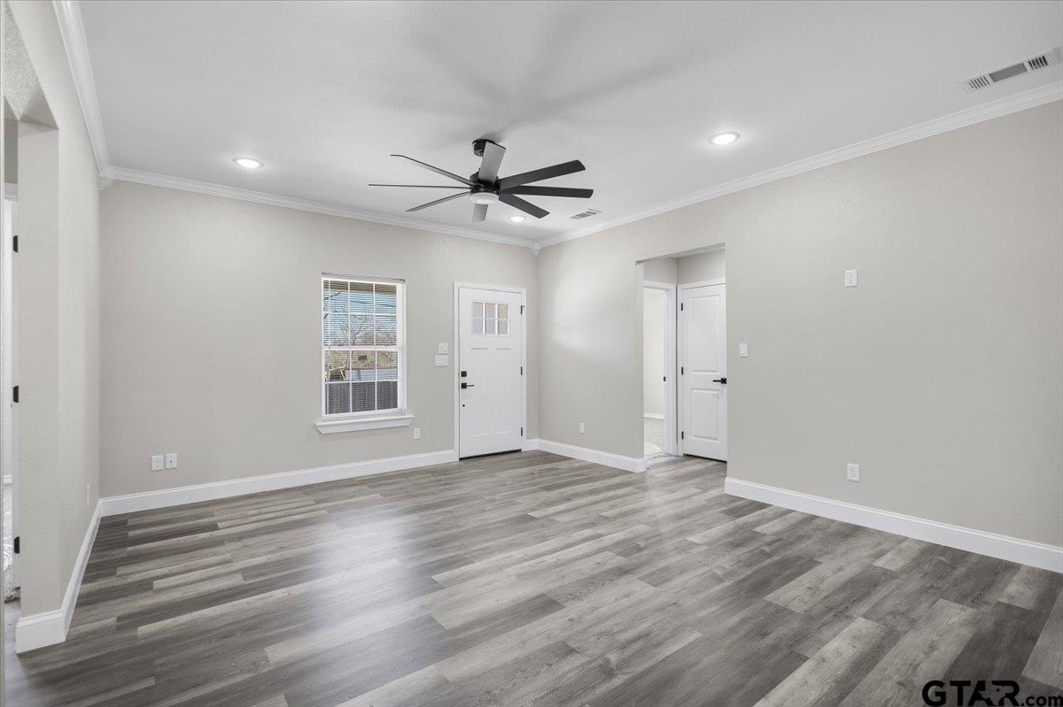 1607 North Ross Avenue Tyler, TX 75702 - Photo 8 of 39 a view of an empty room with wooden floor and a window