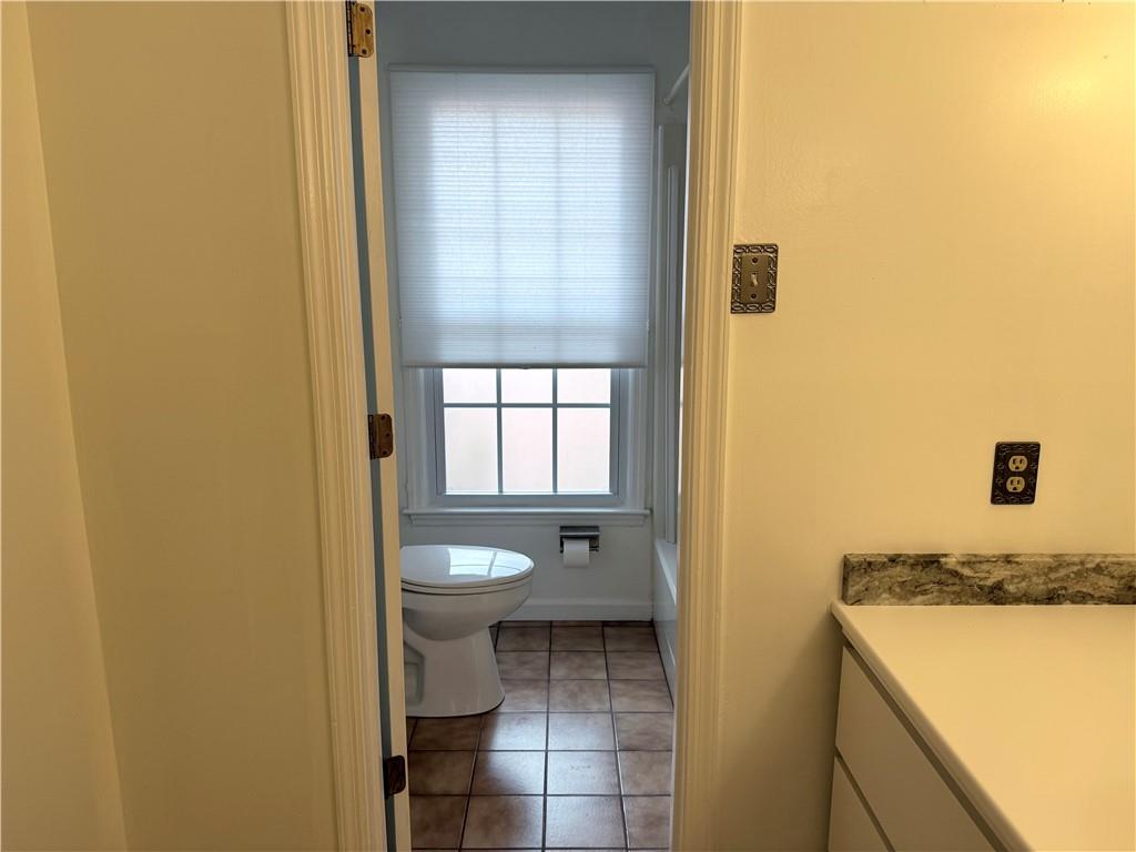 3033 Riviera Drive Conyers, GA 30012 - Photo 26 of 79 a bathroom with a granite countertop sink a toilet and a shower