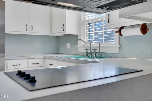 a kitchen with white cabinets and a sink