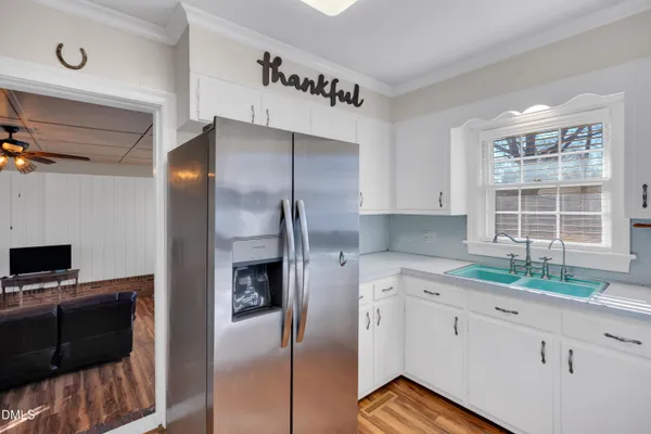 a kitchen with a refrigerator and a stove top oven