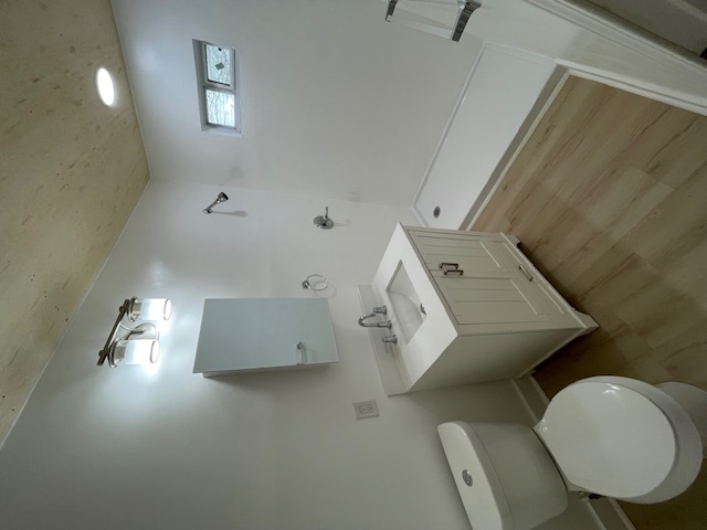 2104 Enfield Road, Unit B Austin, TX 78703 - Photo 13 of 15 a bathroom with a toilet sink and mirror