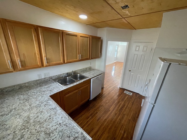 2104 Enfield Road, Unit B Austin, TX 78703 - Photo 4 of 15 a kitchen with wooden cabinets and a stove top oven