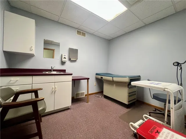 a utility room with cabinets dryer and washer