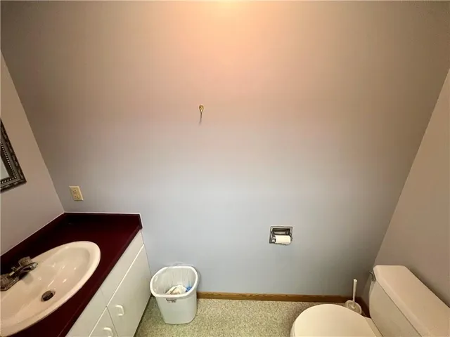 a bathroom with a sink mirror vanity and toilet